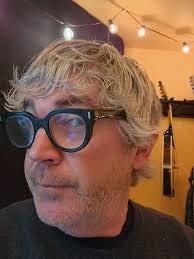 A person wearing black glasses

AI-generated content may be incorrect.