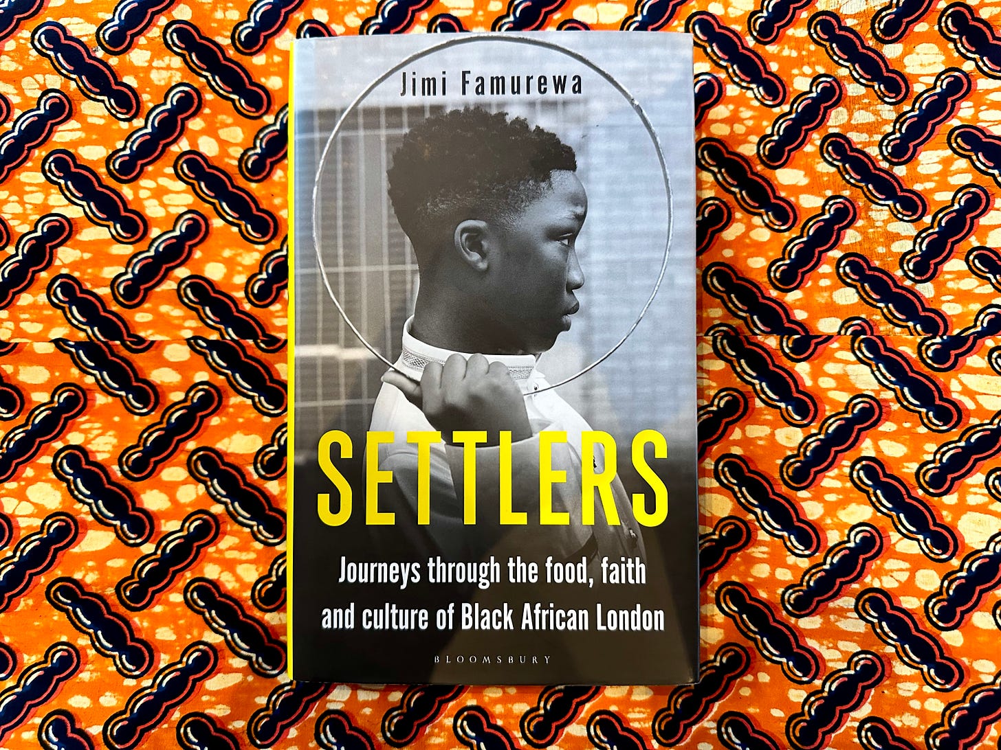 Picture of a book titled "Settlers", by Jimi Famurewa, on a vibrant orange and black African wax print cloth. The cover shows a young Black African boy in profile holding a circular metal hoop that frames his head. The books titles fills the bottom third of the cover. Picture of a book titled "Settlers", by Jimi Famurewa, on a vibrant orange and black African wax print cloth. The cover shows a young Black African boy in profile holding a circular metal hoop that frames his head. The books titles fills the bottom third of the cover.