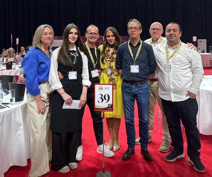 Kristy and her fellow judges from table 39 at the Concours Mondial de Bruxelles, posing together on the red carpet of the judging hall in Yerevan.