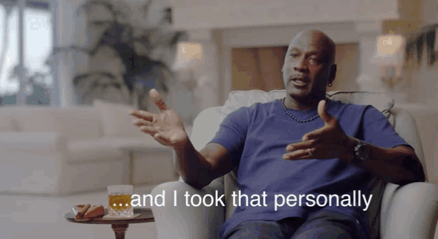 a man sitting in a chair with the words " and i took that personally " behind him a man sitting in a chair with the words " and i took that personally " behind him