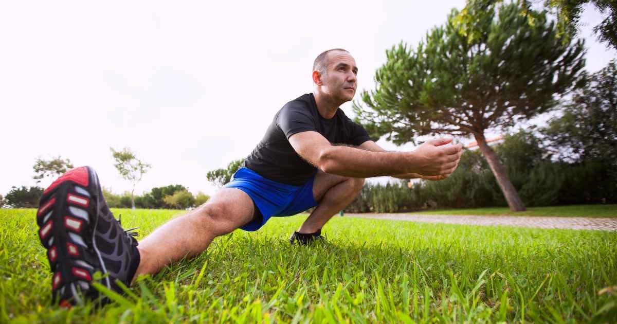 Man doing a deep Cossack squat