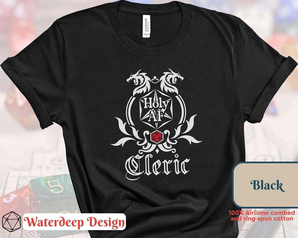 Black t-shirt with "Holy AF Cleric" design featuring fantasy-style scrollwork, dragons, and a red d20. Black t-shirt with "Holy AF Cleric" design featuring fantasy-style scrollwork, dragons, and a red d20.