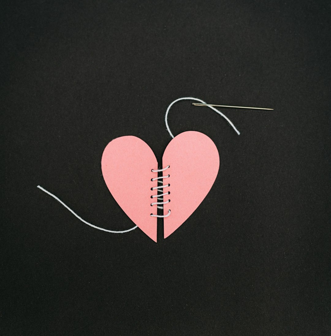 a broken heart with a string attached to it