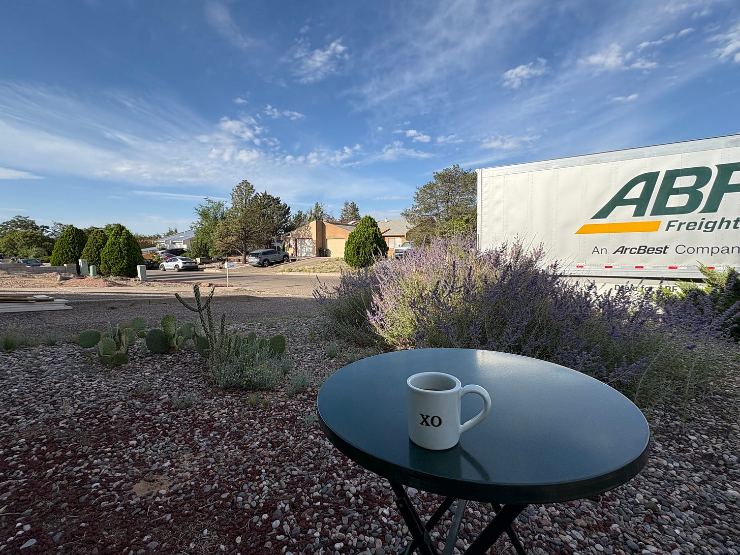 Drinking coffee looking at the ABF Freight moving truck parked outside of our new house