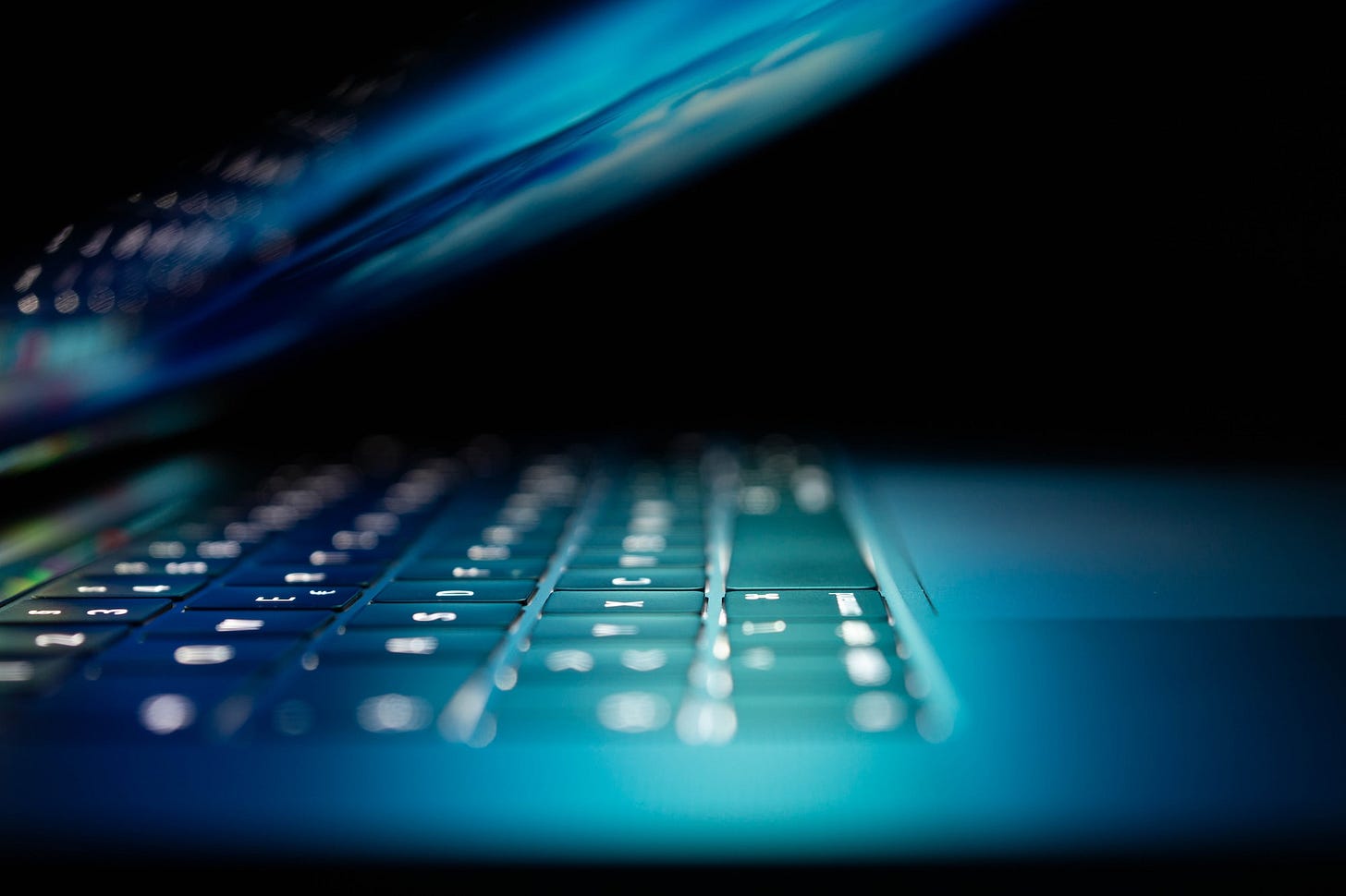 closeup photo of turned-on blue and white laptop computer closeup photo of turned-on blue and white laptop computer