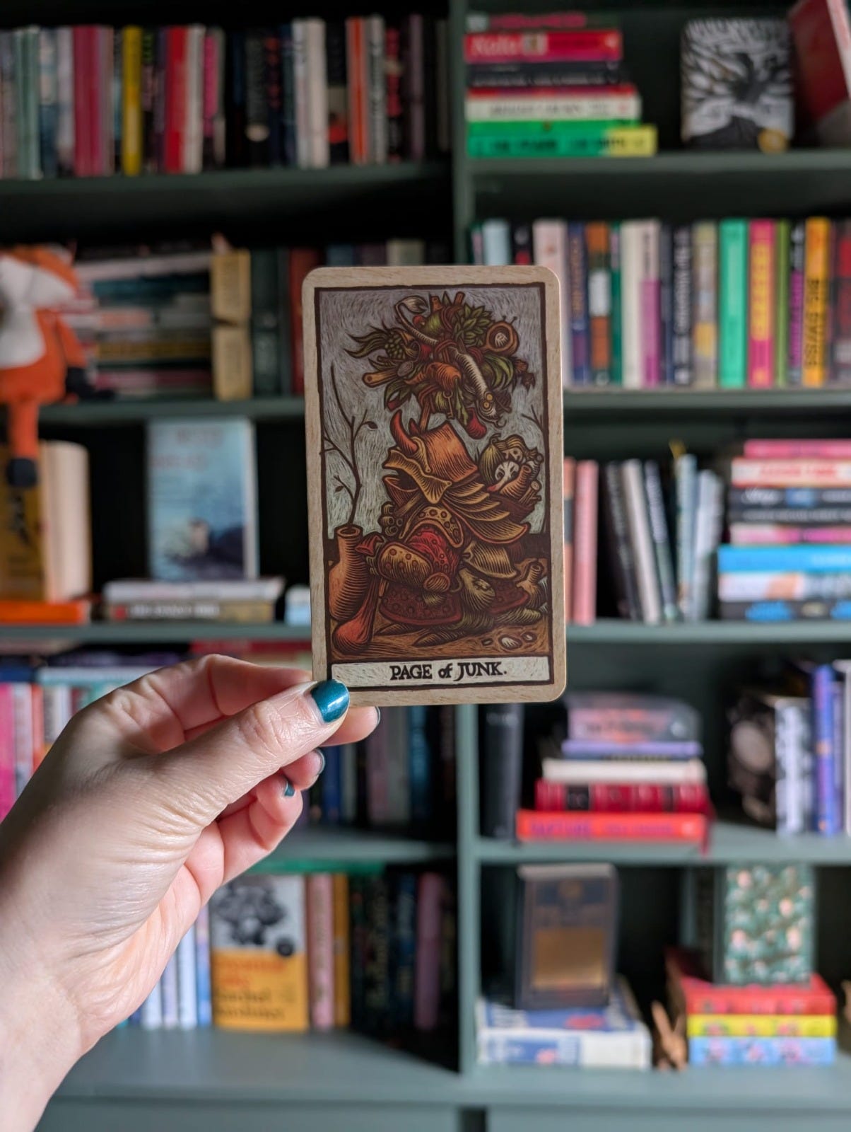 Page of Junk tarot card from Labyrinth themed deck showing figure carrying gathered objects - symbolic reference to memory, accumulation and uncanny childhood imagery. Page of Junk tarot card from Labyrinth themed deck showing figure carrying gathered objects - symbolic reference to memory, accumulation and uncanny childhood imagery.