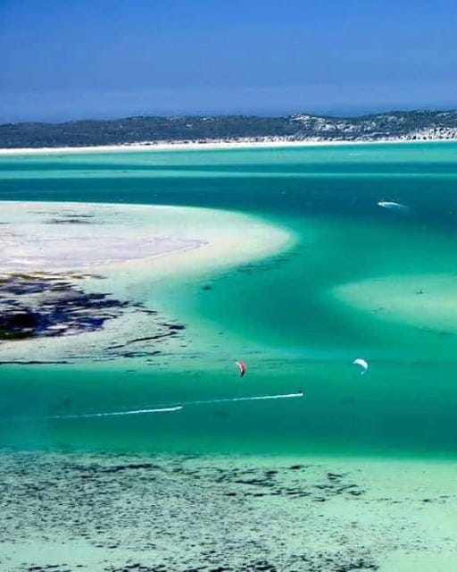 May be an image of parasail, beach and ocean