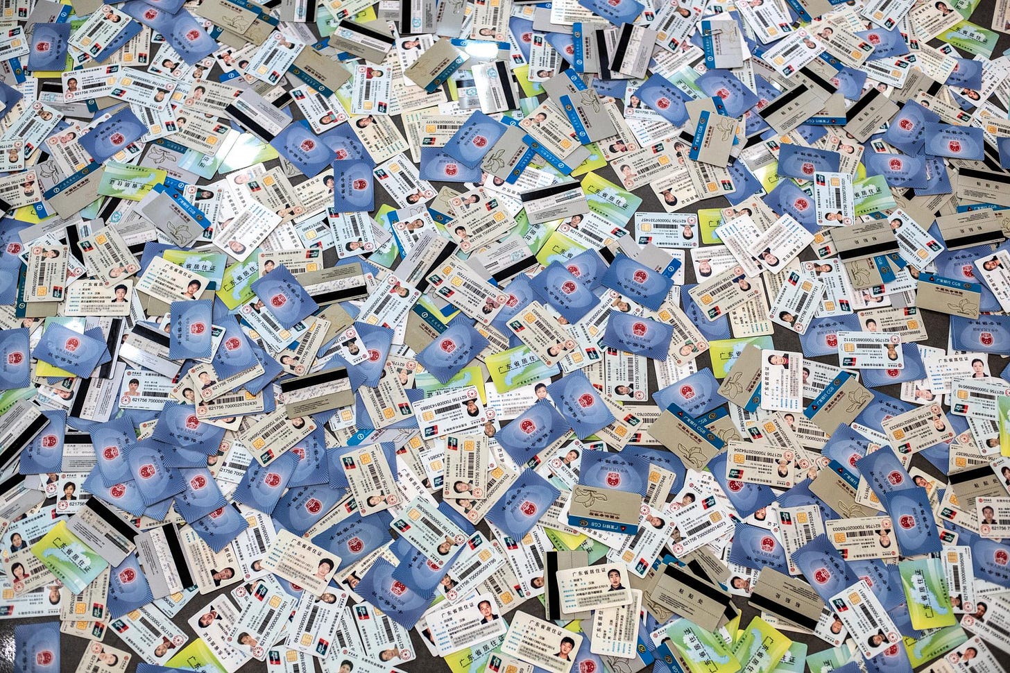 a pile of hundreds of Chinese ID cards spread out on the floor and viewed from above a pile of hundreds of Chinese ID cards spread out on the floor and viewed from above