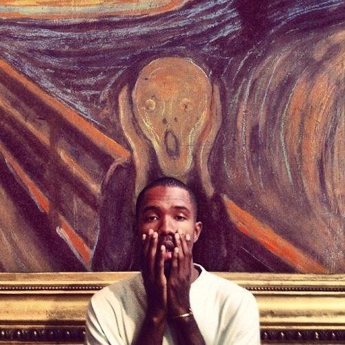 This may contain: a man covering his mouth in front of a painting