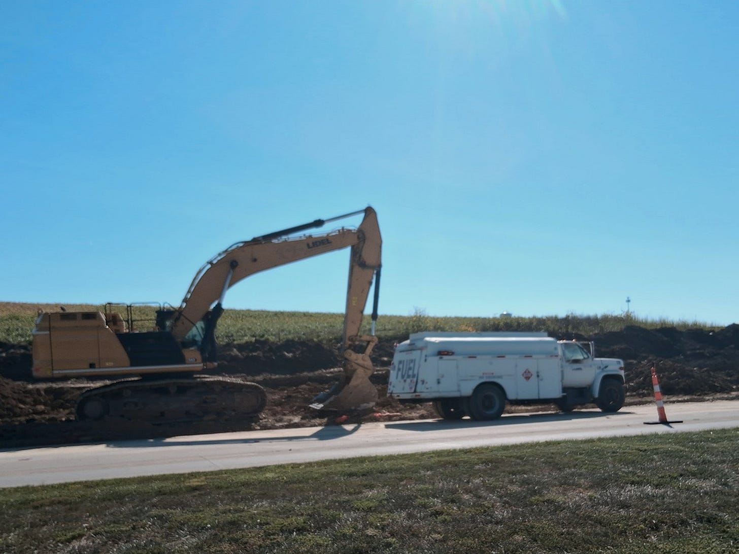 Road construction, preparing to refuel an excavator