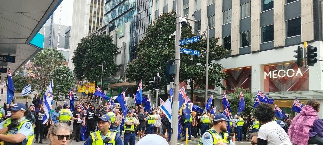 Another group of counter-protesters are making their way down Queen Street, behind the march. Credit: Hayley Smith / RNZ.