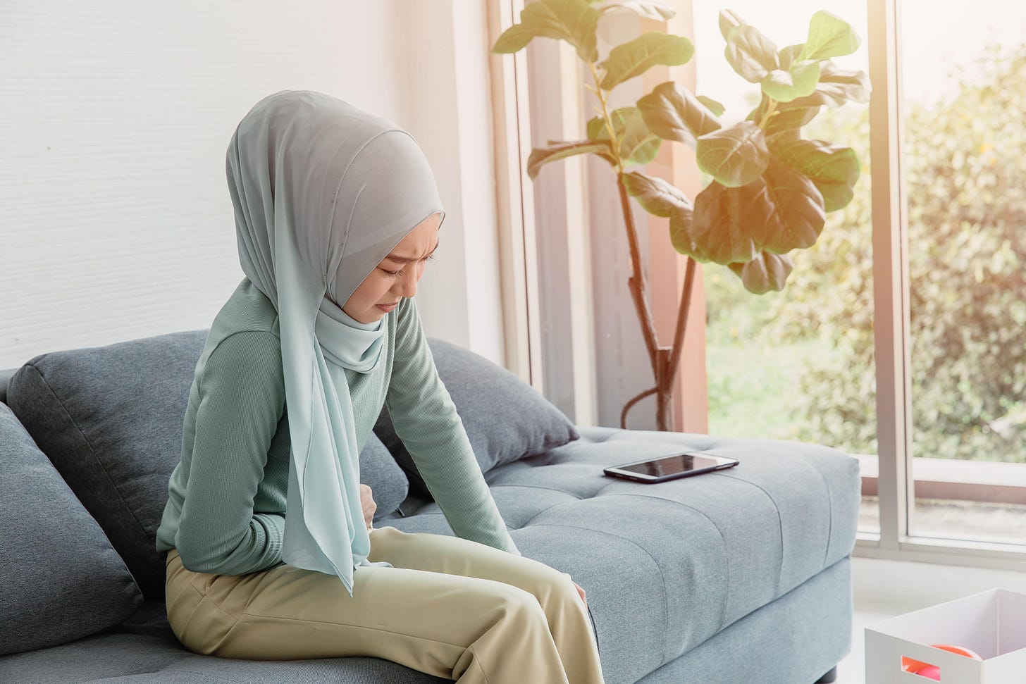 A young Muslim woman with period cramps