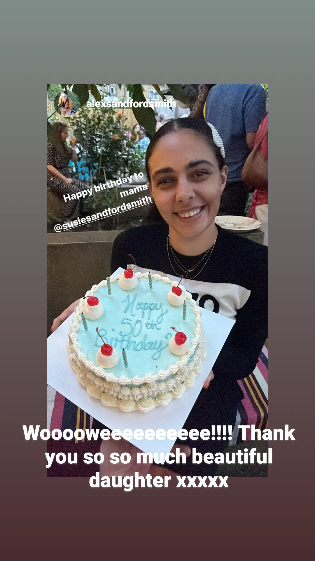 A screenshot of an Instagram story showing a young woman holding a large elaborately iced birthday cake with the words "Happy 50th Birthday" on it.