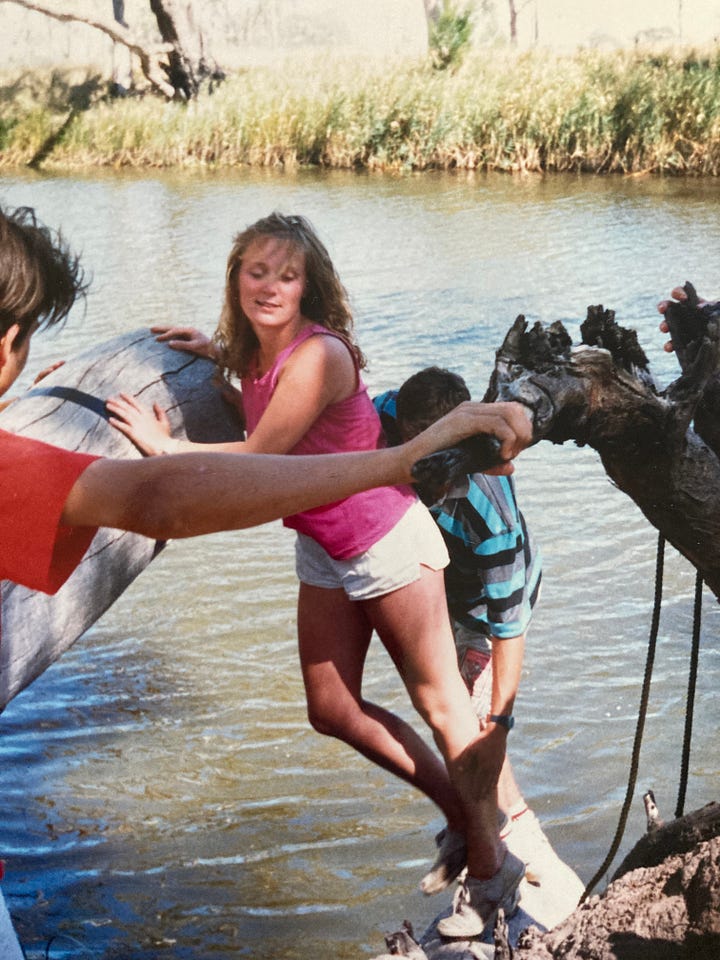 Four images of a young white woman. In one she is smiling, sitting in a garden. In another she is climbing on timber at a water's edge, another she's walking along a beach looking serious and the last she looks like she has a secret