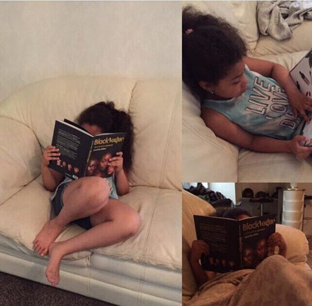 Young Black girl engrossed in reading Black Vogue: Skönhetens Nyanser, a groundbreaking book celebrating Black beauty and representation in Sweden. The book challenges Eurocentric beauty standards and amplifies the diversity of Black identity.