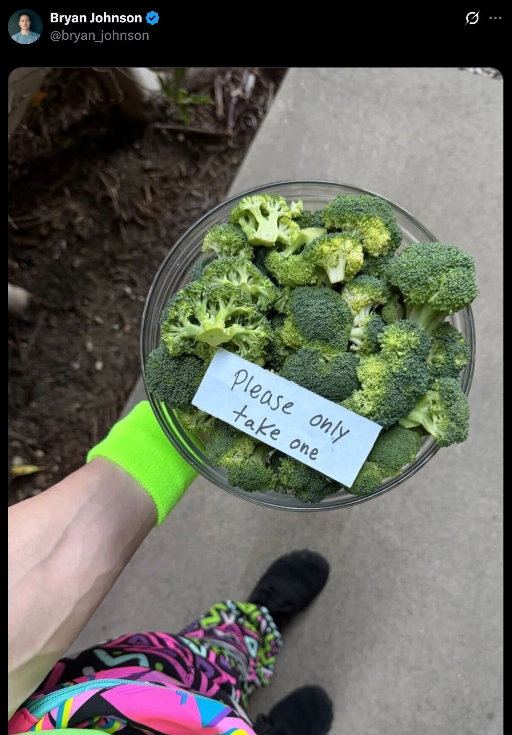 Tweet from @Bryan Johnson that's a pic of a bowl of broccoli and a sign that says "please take only one"