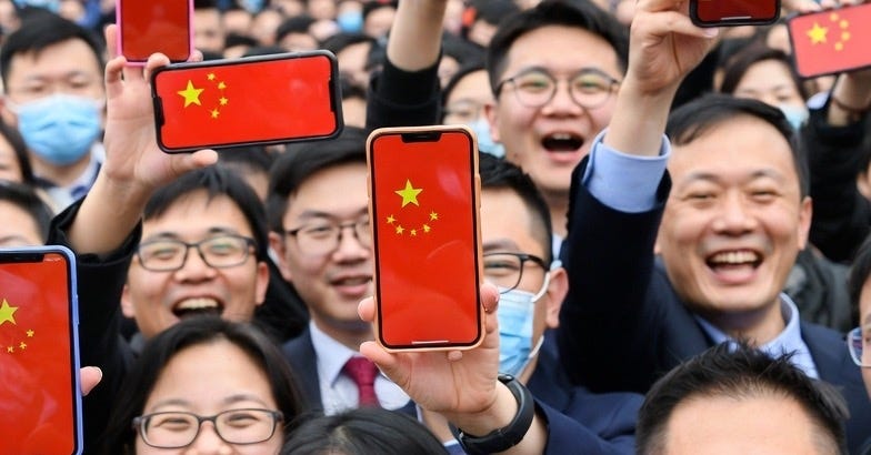 A group of Chinese people celebrating technological achievement with smartphones displaying the flag in an urban setting. A group of Chinese people celebrating technological achievement with smartphones displaying the flag in an urban setting.