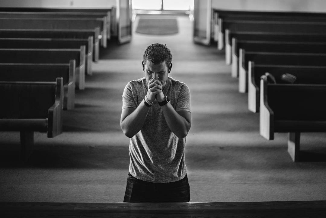 man standing near altar praying