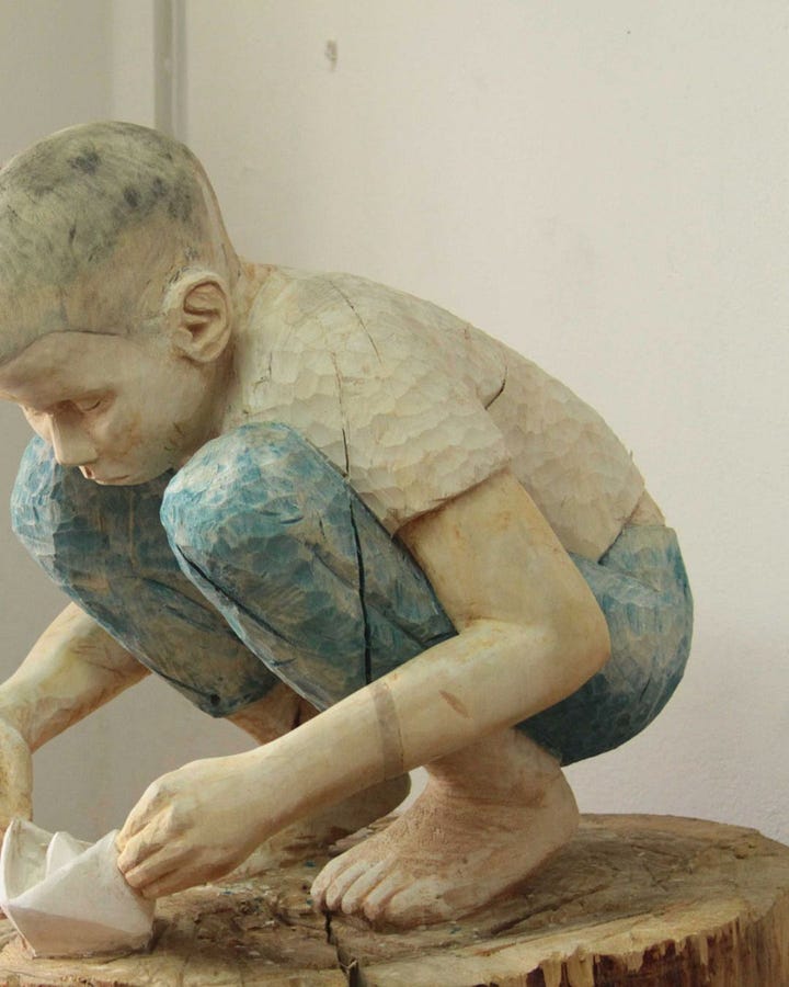 Figurative wood sculpture by Tina Schneider, blending organic form with raw emotional presence. Image courtesy of the artist.