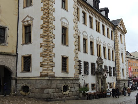 photos of buildings, a cathedral. a plaque, and a gravestone embedded in a wall