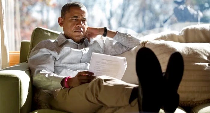 a photo of Obama reading a photo of Obama reading