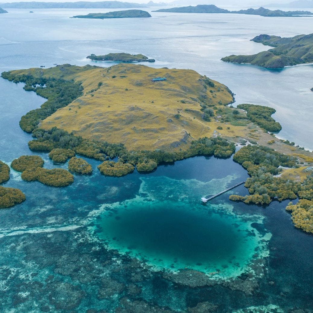 View of Sebayor Kecil Island in Komodo National Park, Indonesia, surrounded by clear turquoise waters and vibrant coral reefs. View of Sebayor Kecil Island in Komodo National Park, Indonesia, surrounded by clear turquoise waters and vibrant coral reefs.