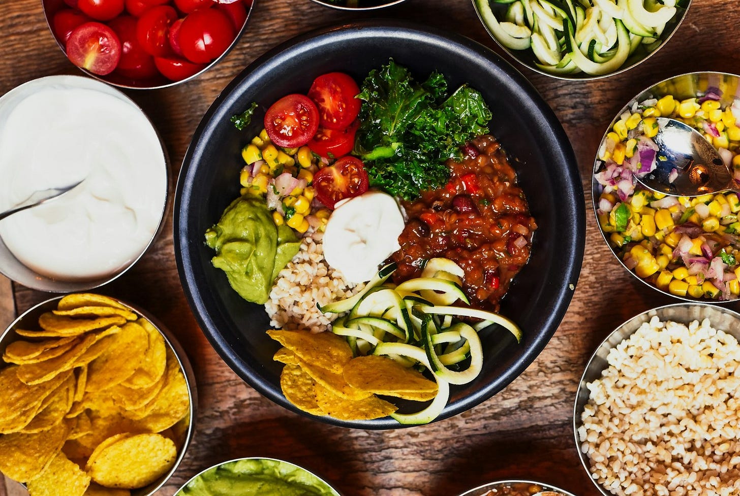 sliced tomato and green vegetable on black ceramic plate