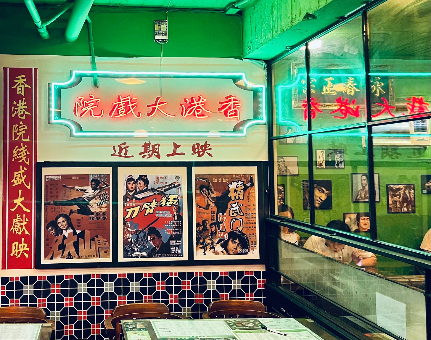 Green and red neon lights and Bruce Lee posters decorate the walls of Boji HK Style Restaurant in Taipei's Da'an District Green and red neon lights and Bruce Lee posters decorate the walls of Boji HK Style Restaurant in Taipei's Da'an District