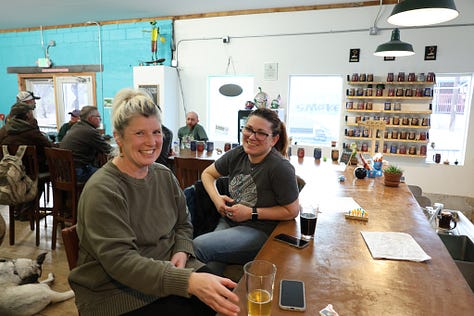 People drinking beer sitting down and standing up with frogs and toads in the background