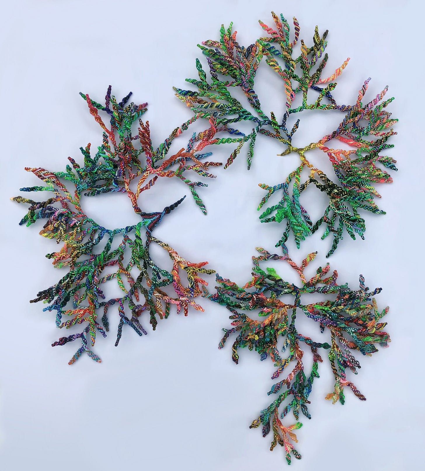 Multicolored branches made of lanyard. This interactive sculpture is formed of three large parts that can be displayed together or separately in various positions. As they spread out, the organic, colourful and ever-changing shapes mirror corals, lichens, and other organisms found in nature. Multicolored branches made of lanyard. This interactive sculpture is formed of three large parts that can be displayed together or separately in various positions. As they spread out, the organic, colourful and ever-changing shapes mirror corals, lichens, and other organisms found in nature.