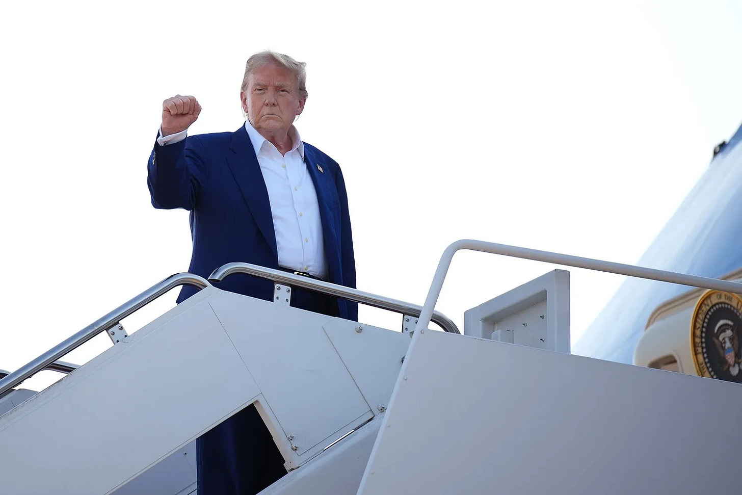 U.S. President Donald Trump boards Air Force One to depart for the 2025 NATO summit.