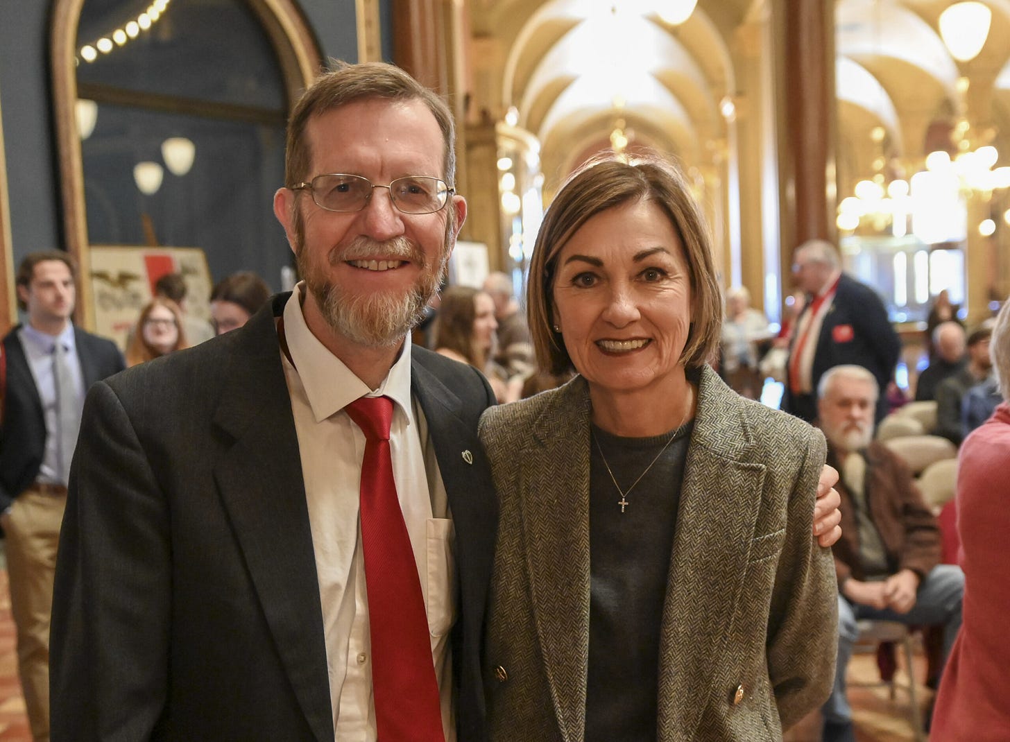 Governor Kim Reynolds smiling stands beside Chuck Hurley (TFL Vice President and former Iowa legislator) at the 2025 Prayer for Life event inside the Iowa Capitol, illustrating The Family Leader's access to state executive leadership. Governor Kim Reynolds smiling stands beside Chuck Hurley (TFL Vice President and former Iowa legislator) at the 2025 Prayer for Life event inside the Iowa Capitol, illustrating The Family Leader's access to state executive leadership.