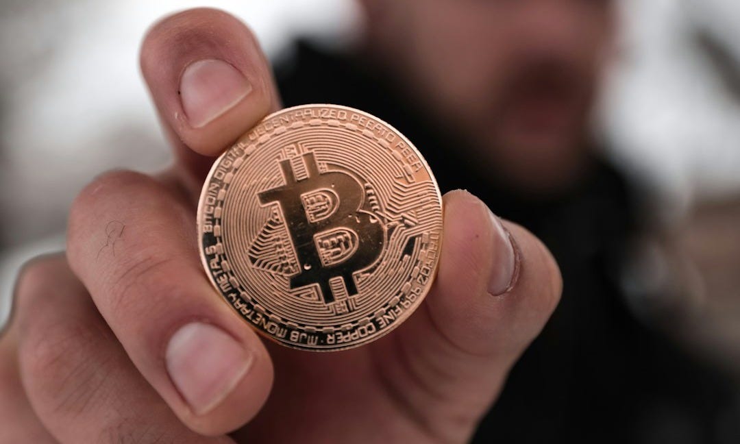 a person holding a coin