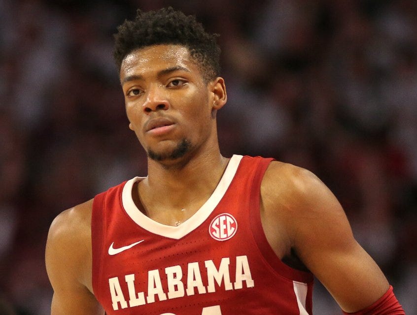 Brandon Miller in a red Alabama No. 24 jersey during a game, with a blurred crowd behind him. Brandon Miller in a red Alabama No. 24 jersey during a game, with a blurred crowd behind him.