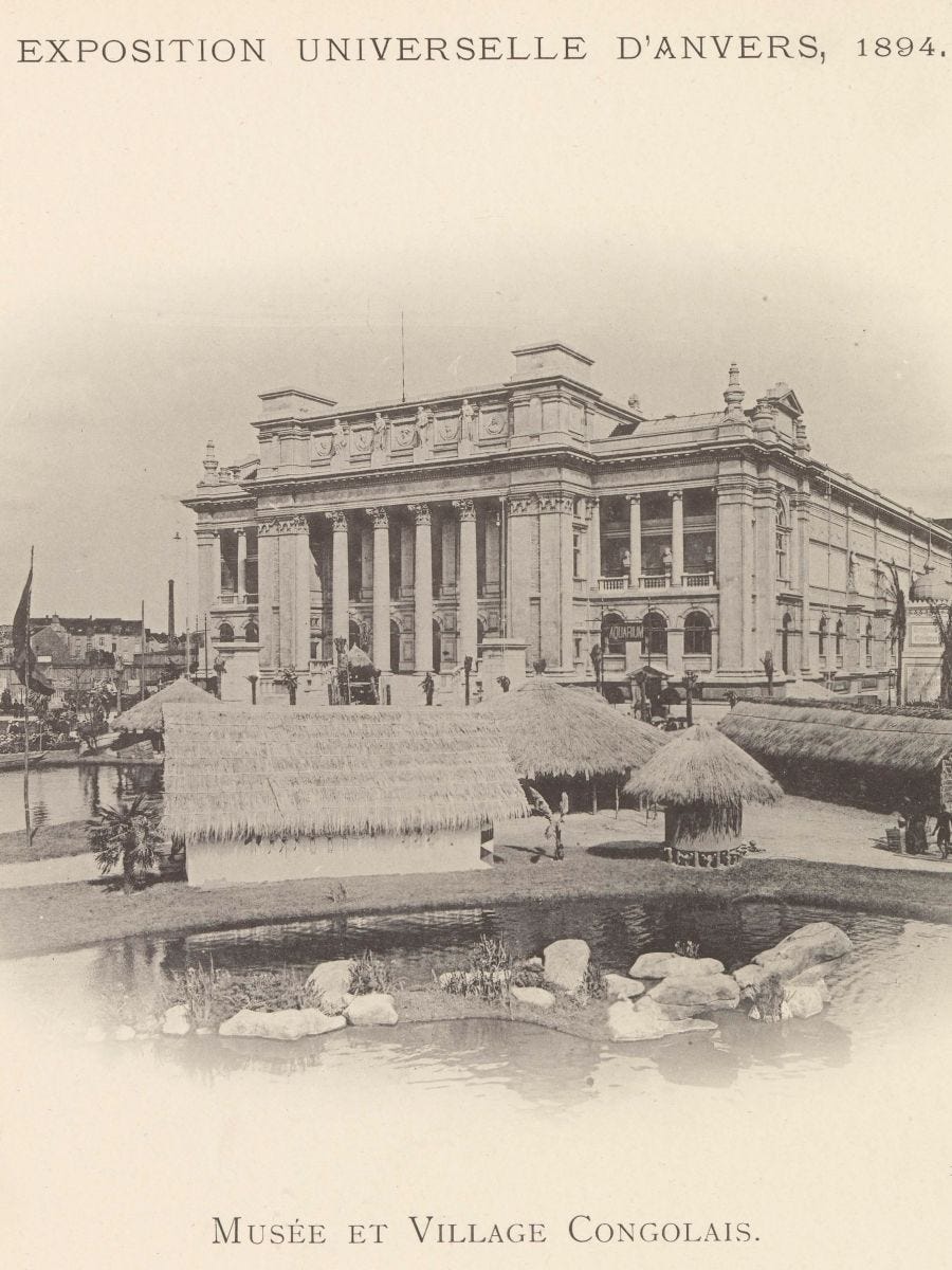 Faded black and white photo of Antwerp's Koninklijk Museum voor Schone Kunsten possibly taken taken in the early twentieth century. The familiar neoclassical building is in the background. In the foreground is a Congolese village which was a popular expo feature until the mid twentieth century in Belgium who relied on Congolese adults and infants who were often coerced or forced, then transplanted. Many fell sick (especially in winter) and died, not to say anything of the psychological harms that such public display must have caused.