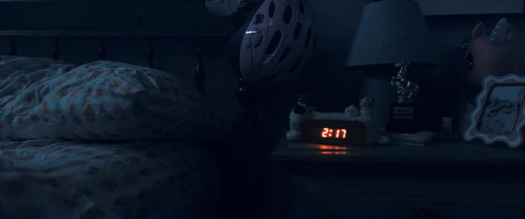 A dark bedroom, and the only light is red from the alarm clock that reads "2:17" A dark bedroom, and the only light is red from the alarm clock that reads "2:17"