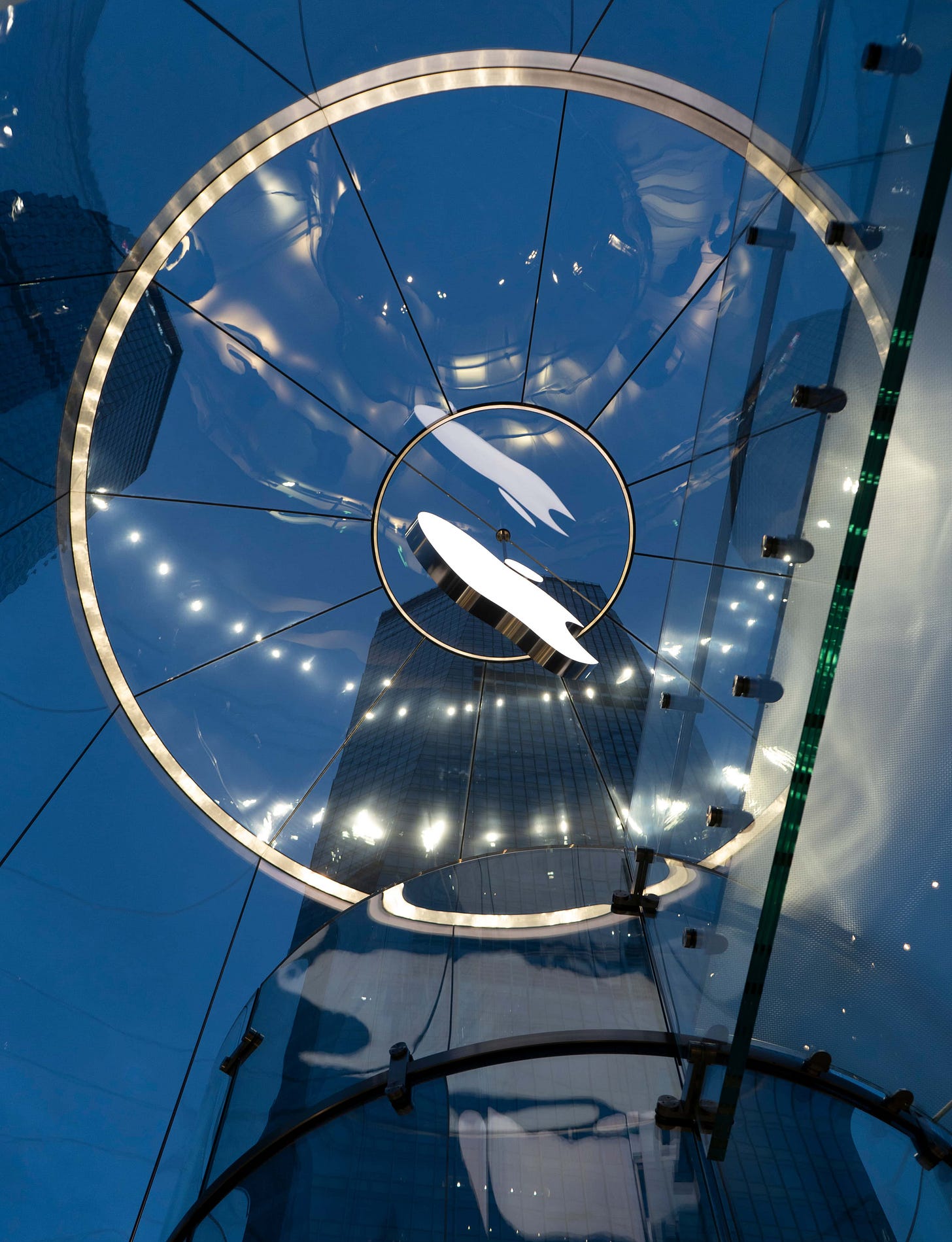 The interior of the glass drum entrance to Apple Pudong, photographed at night from the store floor. The interior of the glass drum entrance to Apple Pudong, photographed at night from the store floor.