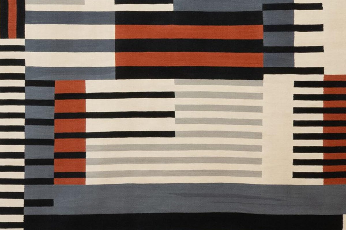 A geometric textile by Anni Albers composed of carefully woven horizontal and vertical threads that form a balanced pattern of repeating shapes, textures, and subtle color variations.