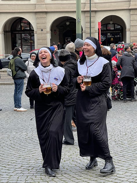 Masked figures in fur and straw costumes during Prague's Masopust, the Czech pre-Lenten carnival.