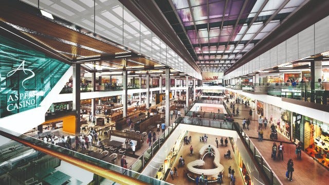 Bird's-eye view of the interior of Westfield Stratford City in east London, a modern shopping mall. Many people walk between shops and the glass fronts of retail outlets. Bird's-eye view of the interior of Westfield Stratford City in east London, a modern shopping mall. Many people walk between shops and the glass fronts of retail outlets.