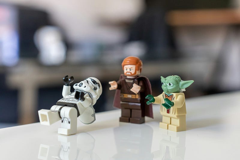 A Lego Luke and Yoda is defeating a Stormtrooper