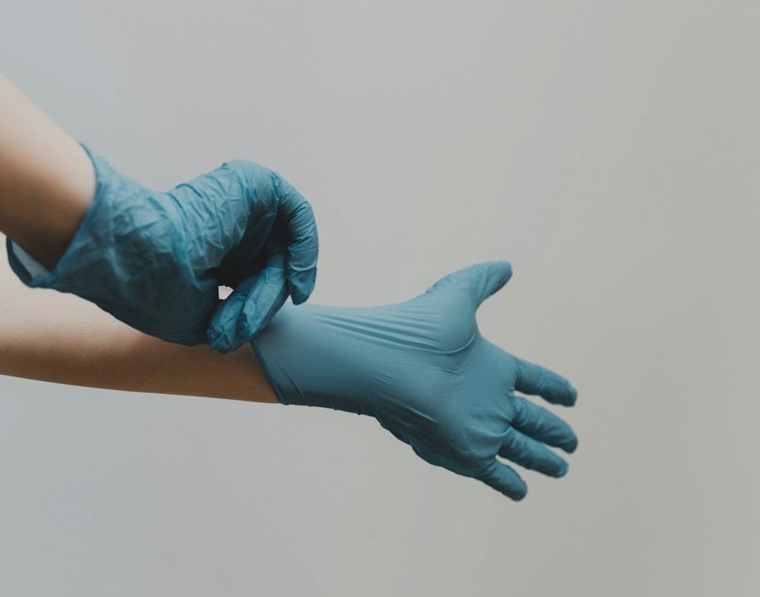 person in blue gloves and blue denim jeans person in blue gloves and blue denim jeans