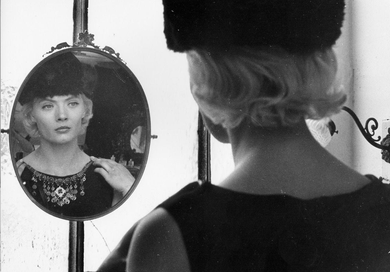 A still from Cleo from 5 to 7. Cleo looks into a mirror. A still from Cleo from 5 to 7. Cleo looks into a mirror.