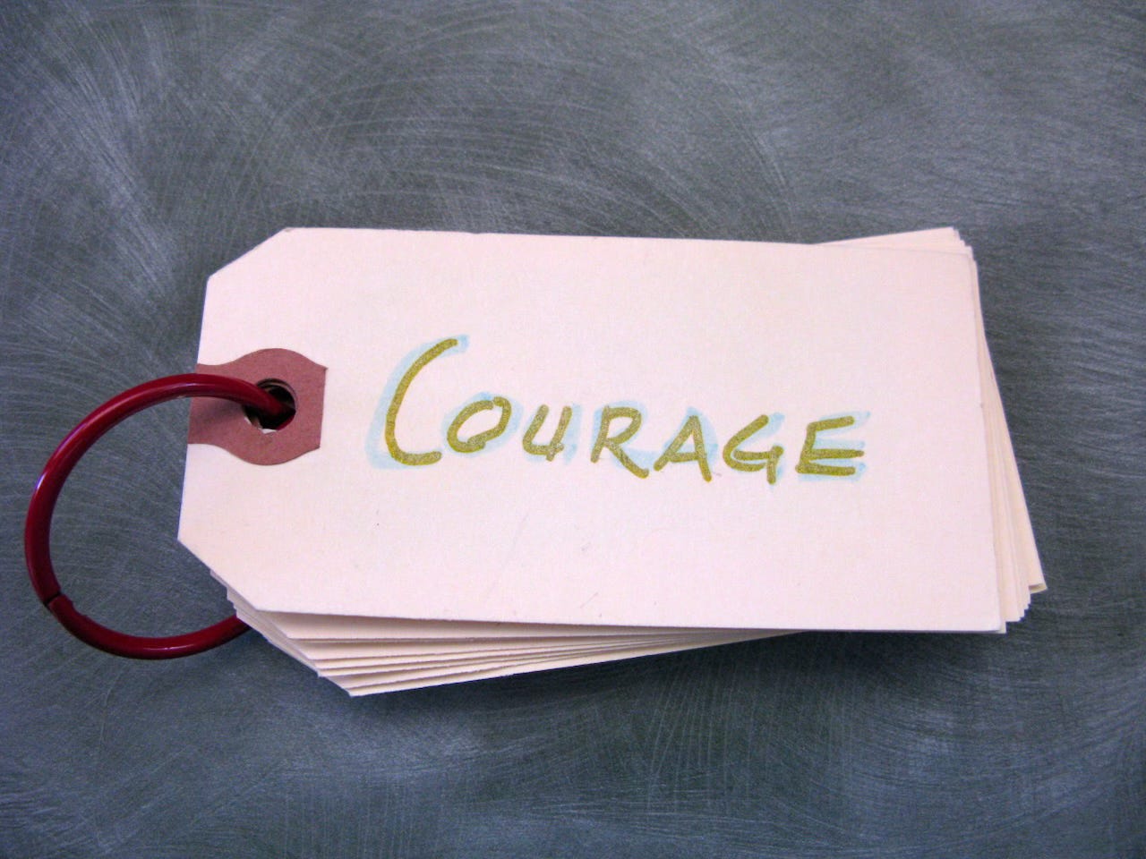 Hand-lettered label that says "courage" in gold and blue ink on a binder ring. Intention cards Hand-lettered label that says "courage" in gold and blue ink on a binder ring. Intention cards