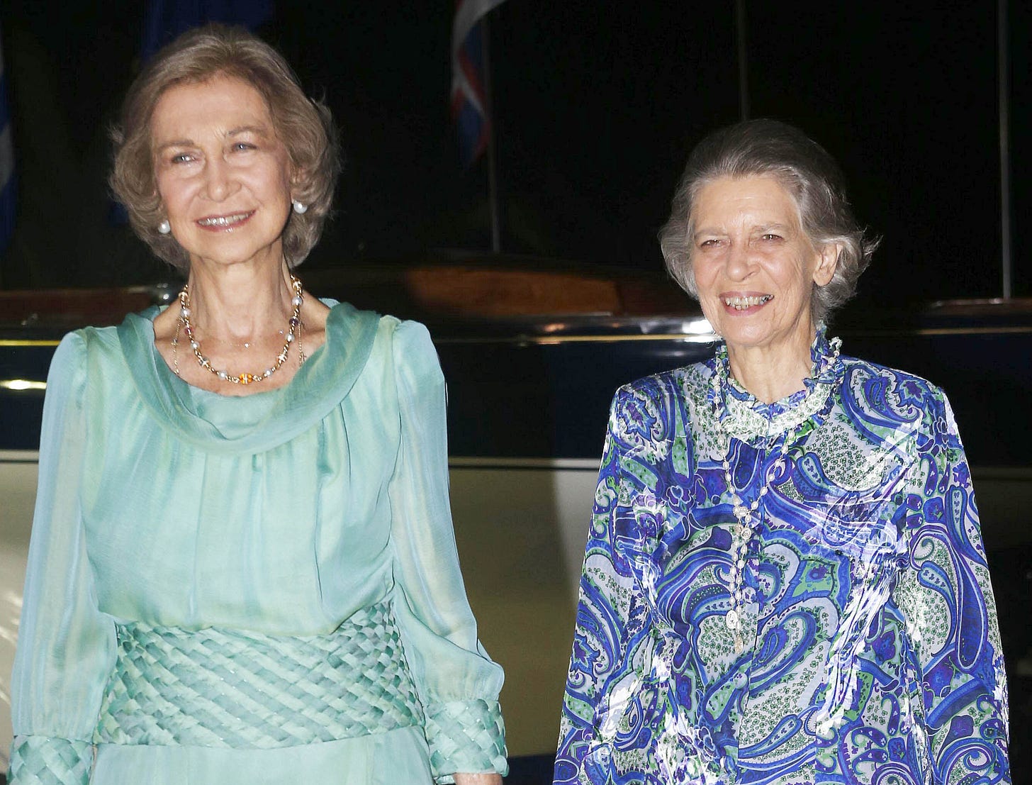 Queen Sofia in a mint green dress and Princess Irene in a blue patterned dress