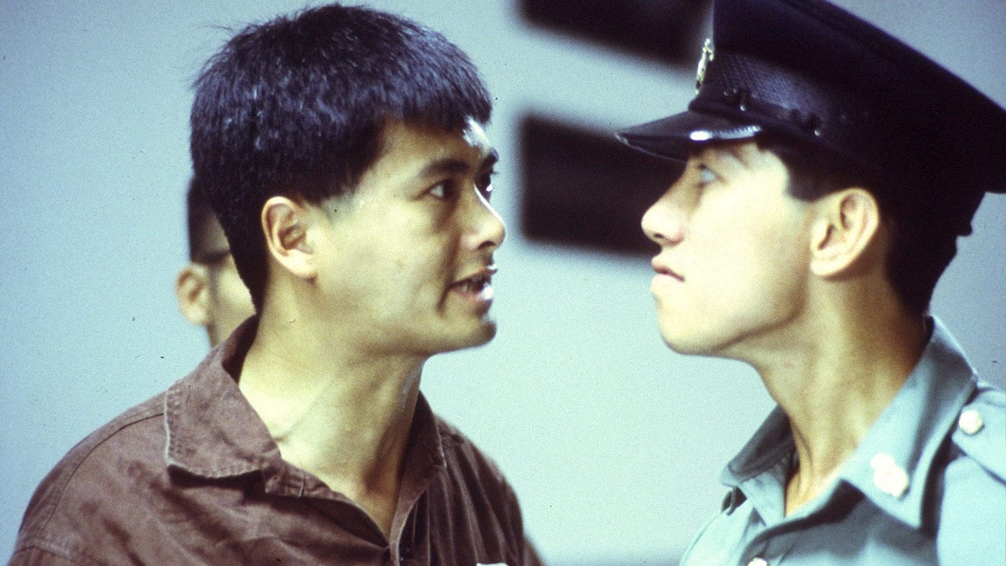 Prison on Fire | Still features Chow Yun-fat staring down Roy Cheung.