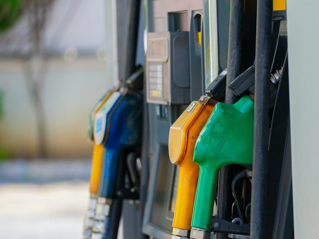 a row of gas pumps filled with gas