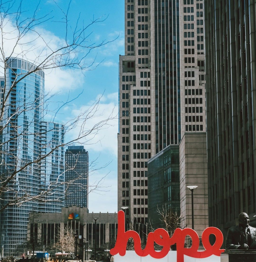 Cityscape featuring the word "hope" in a plaza. Cityscape featuring the word "hope" in a plaza.