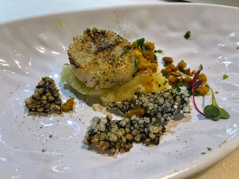 A single scallop with bread crumbs and puffed rice crips, a whole battered and fried crab, a cute up beef cheek with mashed and fried potatoes