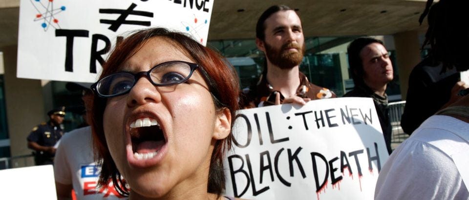 Vanessa Azcona of Denton shouts during a protest outside of the annual shareholders' meeting of ExxonMobil in Dallas